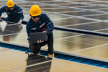 engineer man inspects construction of solar cell panel or photovoltaic cell by electronic device....