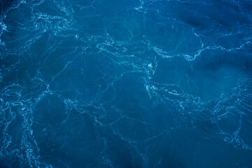 Natural blue waters with white caps. View from a ship. Ocean water.