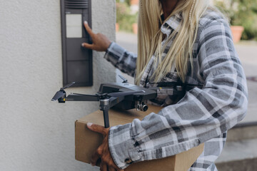 Fast and safe delivery. A drone delivers a gift to a girl, contactless delivery