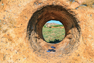 Close-up view of the ancient millstone against the backdrop of an array of sandstone, ancient place...