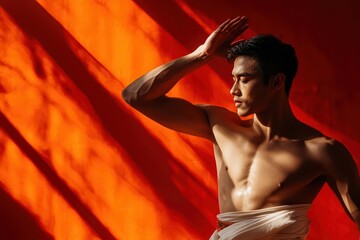 Gold light highlighting a Thai man in traditional attire