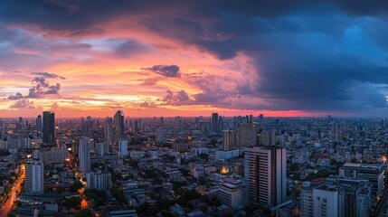 Rooftop view of Bangkok cityscape at sunset, highlighting the Lumpini area and colorful evening sky.