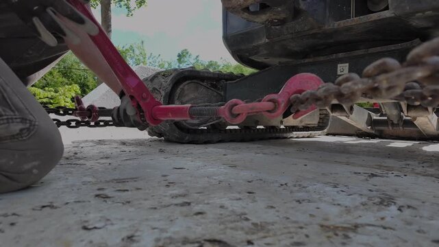 Cargo logistics. Men workers fasten the load on the truck. Close up view