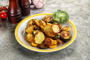 Roasted young zucchini in the plate