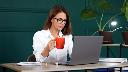 A self-assured professional woman excels in her modern office, exuding a sense of accomplishment...