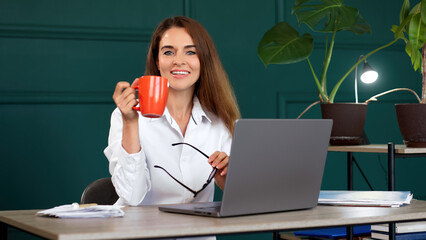 A self-assured professional woman excels in her modern office, exuding a sense of accomplishment...