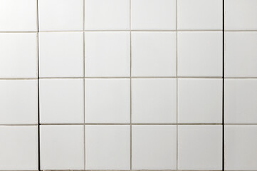 White square tiles on bathroom wall as texture or background