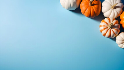 Background with colorful pumpkins on a blue background with copy space.