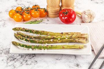 Grilled asparagus sprouts served red pepper