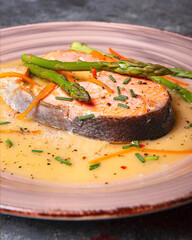 Grilled salmon with green asparagus,g grated carrot and cilantro in lemon cream.
