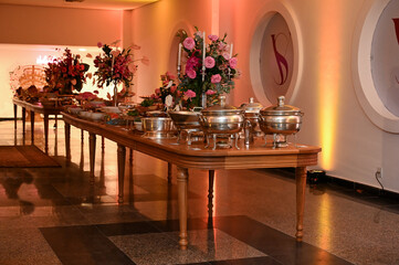 buffet, interior of a hotel, interior of a restaurant, table with food, party buffet, table with food, buffet decorated with flowers
