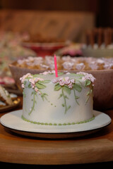  cake with flowers, cake with candle, fondant cake, vintage cake, side view, horizontal
