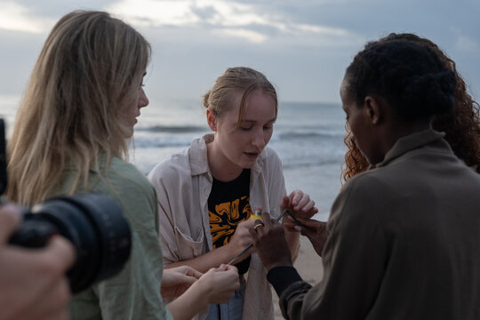 Woman igniting sparklers for the video shoot
