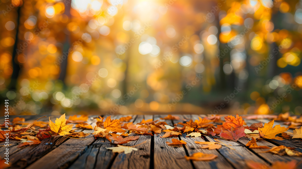 Poster autumn background with a wood table and colorful autumn leaves on a blurred bokeh forest background