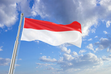 Flag of Indonesia on background of cloudy sky