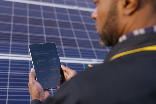 Solar panels worker operating photovoltaic device uniform