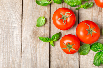 Fresh cherry tomatoes and fresh green basil on a textured background. Tomato sauce. Vegan. Ingredients for salad. Organic food. Place for text. Copy space.