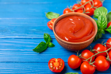 Fresh cherry tomatoes and fresh green basil on a textured background. Tomato sauce. Vegan. Ingredients for salad. Organic food. Place for text. Copy space.