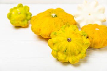 Pattypan zucchini on a textured kitchen table. squash. Fresh organic pattypan squashes on...