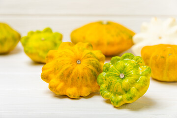 Pattypan zucchini on a textured kitchen table. squash. Fresh organic pattypan squashes on...