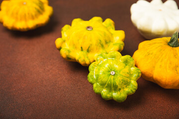 Pattypan zucchini on a textured kitchen table. squash. Fresh organic pattypan squashes on...