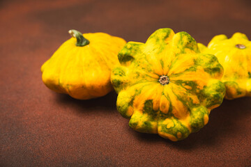 Pattypan zucchini on a textured kitchen table. squash. Fresh organic pattypan squashes on...