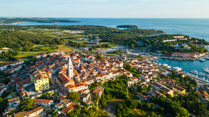 An aerial view of the beautiful old town of Vrsar, Croatia, captured by a drone. This charming coastal town features historic stone buildings, narrow winding streets, and a stunning view 
