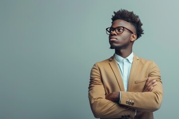 Obraz premium Confident Young Man in Stylish Brown Blazer and Glasses Posing