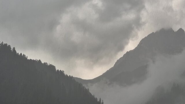 Clouds and rain above Campitello di Fassa and Sassolungo mountain - Val di Fassa - Italy