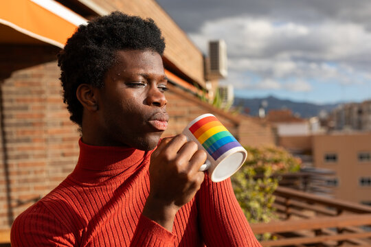 young non-binary boy on the balcony of his house