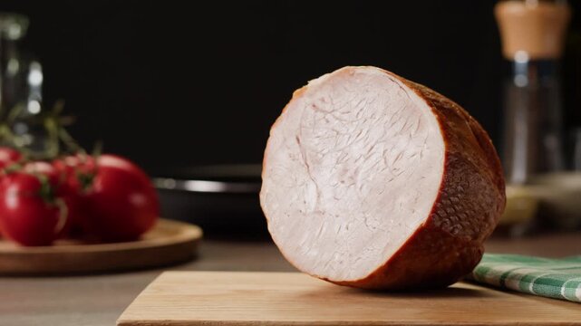 Woman slices ham bacon meat thick pieces on a wooden board, beef or pork jamon. Chef cooking breakfast, smoked bacon in cafe. 