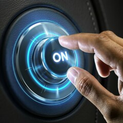 A person's fingers pointing towards a luminous button with the text ON
