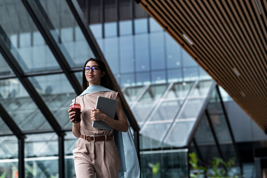 Innovative woman entrepreneur outside coworking with digital tablet