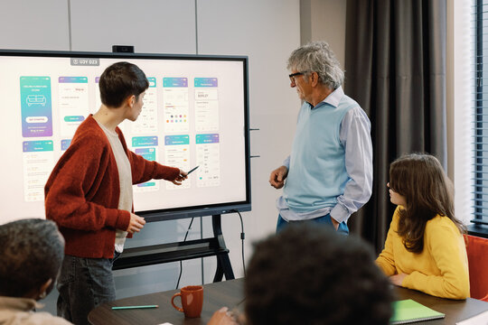 Engaged colleagues digital presentation modern meeting room