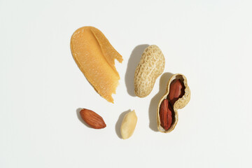 Top view set of peanut butter smear, whole nuts and shell on white isolated background. Natural snacks. Image for your design