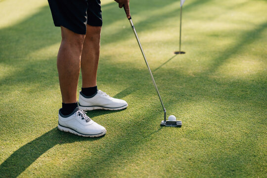 Golfer Putting on Green