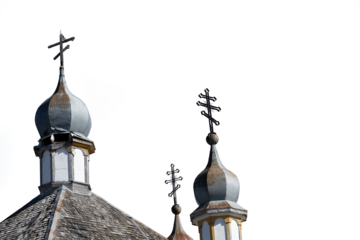 Looking up at a dilapidated Orthodox Christian church with the sky transparent. The detailed photo shows the damage on the church.
