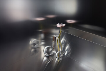 Pink flower standing among artificial material figures