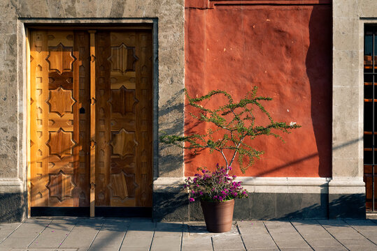 Street view of wooden door and terracotta wall