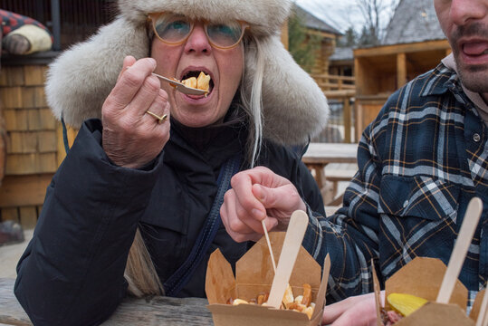 Mother and son sharing poutine on winter day