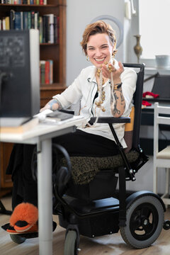 Camera Aware Portrait of a Happy Woman in Wheelchair