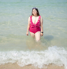 Portrait young asian woman fat chubby cute beautiful smile happy fun enjoy relax bikini swimwear body sexy front view sea beach white sand clean bluesky calm nature ocean wave water travel on holiday