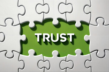 Fototapeta premium 3d illustration render puzzle piece with the text word TRUST revealing from hidden jigsaw puzzle piece