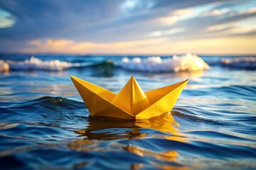 Yellow paper boat floating in the ocean