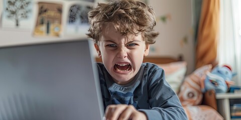 angry child using laptop, bedroom background, copy space 