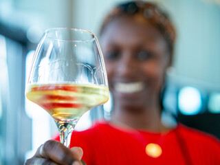 young woman drinking a glass of white wine