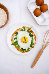 Pancake with eggs, cream cheese, arugula, spatula, oatmeal for healthy breakfast on white background top view.