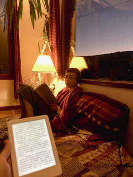 POV A woman is portrayed during her reading time.