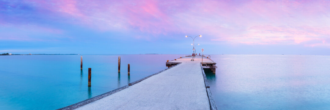 A calm sunrise at coastal jetty at beach