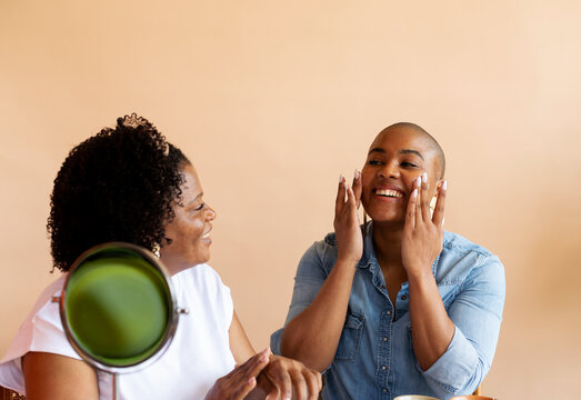woman putting cream on her face